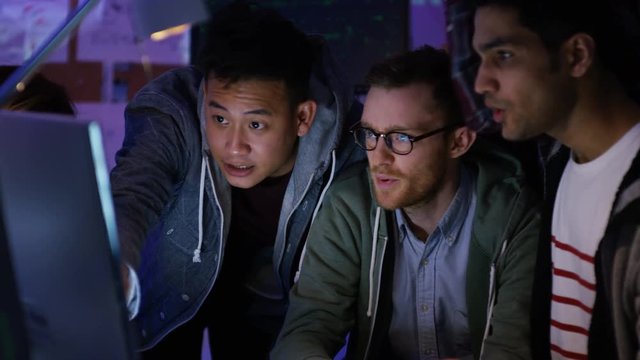  Team of young computer hackers trying to gain access to a computer system