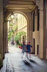 Fototapeta na wymiar people walking along beautiful narrow european street