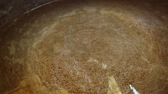 Swaying Water in an Iron Cauldron Closeup