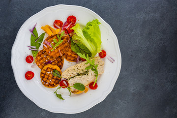 Grilled sweet potatoes and roast turkey with herbs
