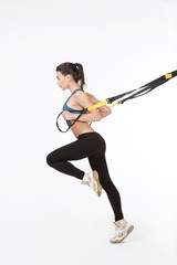 TRX concept. Picture of fitness trainer posing for photographer while training with suspension...