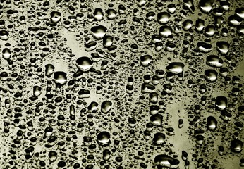 closeup drops water on gold background