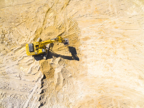 Aerial view of a excavator in the mine. Industrial background on mining theme.