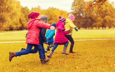 group of happy little kids running outdoors