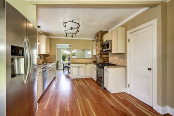 Kitchen room with white cabinets, stainless steel and hardwood floor