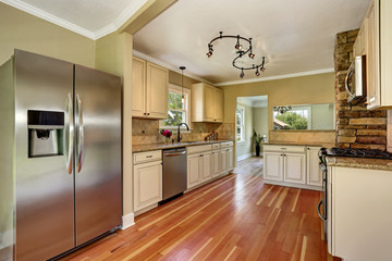 Kitchen room with white cabinets, stainless steel and hardwood floor