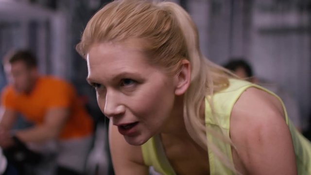  Close up of woman working out on exercise bike at the gym