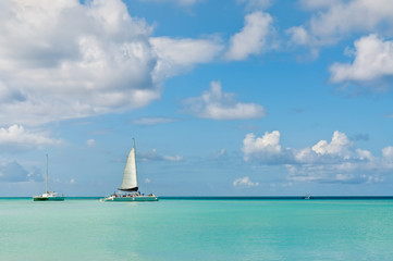 Idyllic blue beach with boats, Aruba island - Caribbean sea