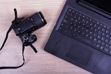 Lay flat image of a laptop and camera