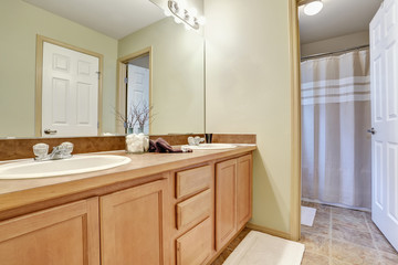 Fototapeta na wymiar Bathroom interior with vanity and white shower curtain.