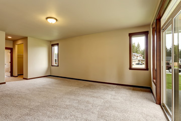 Empty room interior in beige tones and carpet floor.