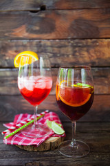 Sangria  and ingredients in glasses  on a rustic wood