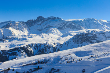 Fototapeta na wymiar View of snow covered Courchevel slope in French Alps. Ski Resort