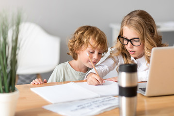 Girl teaching her little brother