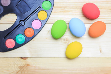 Plakat Colorful of eggs and painting color on the wooden floor, Easter.