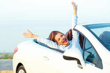Freedom - happy free woman in cabriolet cheering joyful with arm