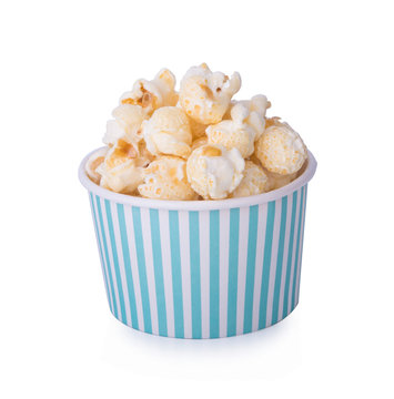 caramel corn in paper cup on white