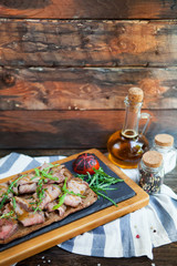Cold meat plate and bread on wooden background