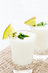 Yogurt mix with green kiwi on white background