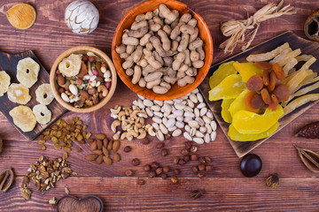 Fototapeta premium Nuts and dry fruit, in plates, on boards