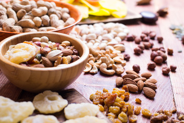 Nuts and dry fruit, in bowls, on boards