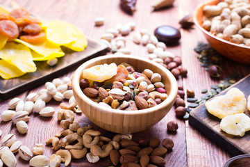 Nuts and dry fruit, in bowls, on boards