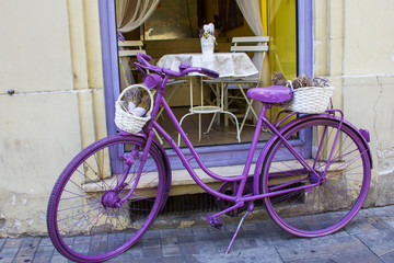 Fototapeta na wymiar Vintage Style Purple Painted Bicycle in Vienna Street