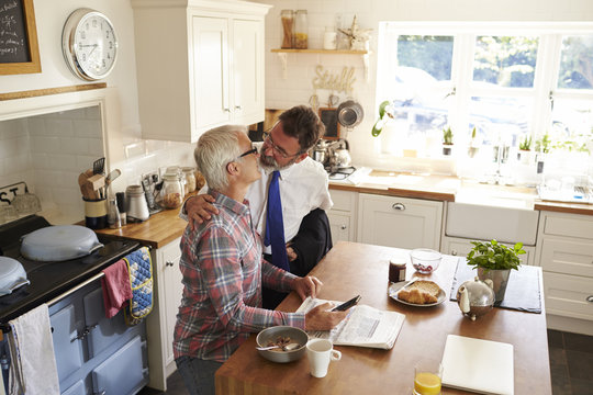 Mature couple standing in kitchen