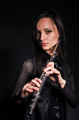 a young girl playing the flute © sushytska