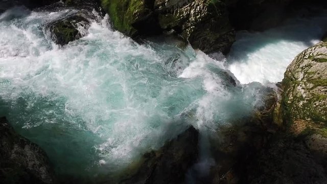 4K. Wild Radovna river flows in Vintgar Gorge. Clean blue water and green forest. Triglav National Park, Julian Alps, Bled valley, Slovenia, Europe.