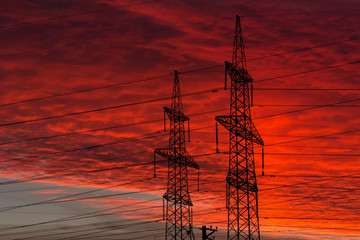 Electric power transmission lines at sunset.