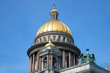 Fototapeta na wymiar The Dome of St. Isaac's Cathedral on a background of blue summer sky close-up. Saint Petersburg