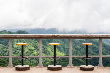The seat on the balcony overlooking the hills and sky.