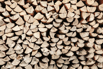 Neat stack of cut wood, textured background