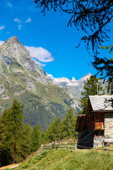 Cabins facing mountains in Italian wilderness