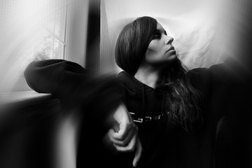 young woman daydreaming at home, thinking imagining,