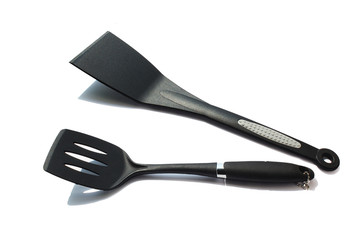 Black plastic kitchen spatula isolated on white