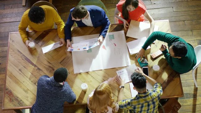  Overhead view of creative business team in a meeting