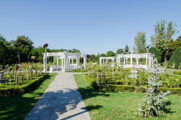 A nice gazebo and a bench painted in white in a par