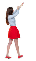 back view of standing girl pulling a rope from the top or cling to something. girl  watching. Rear view people collection.  backside view of person.  Isolated over white background. Long-haired