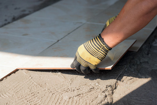 Installing tiles floor in construction work
