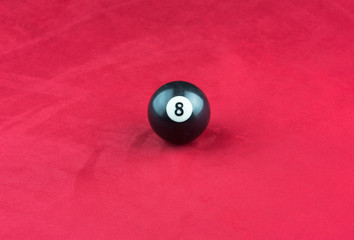 black billiard ball on a red pool table, 8