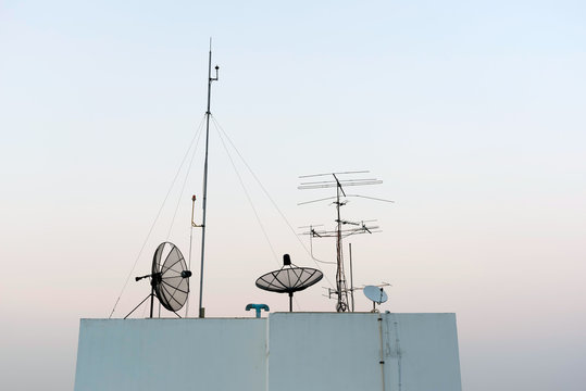 Satellite Dishes and TV antennas  on skyscraper in Bangkok in the morning