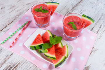 Glasses of watermelon smoothie on a wooden table