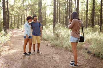 Friends taking pictures in a forest