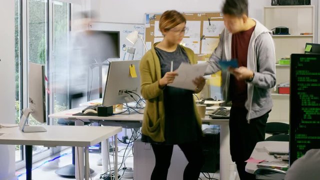  Time lapse of young computer experts working in office with lots of computers