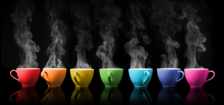 Hot drink mug the rainbows color placed on colour black background