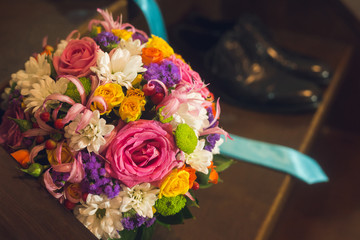 Beautiful composition with a flower bouquet and wedding shoes