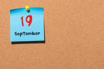 September 19th. Day 19 of month, color sticker calendar on notice board. Autumn time. Empty space...