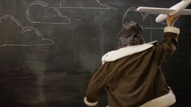  Portrait of thinking man sitting in front of blackboard with math formulas